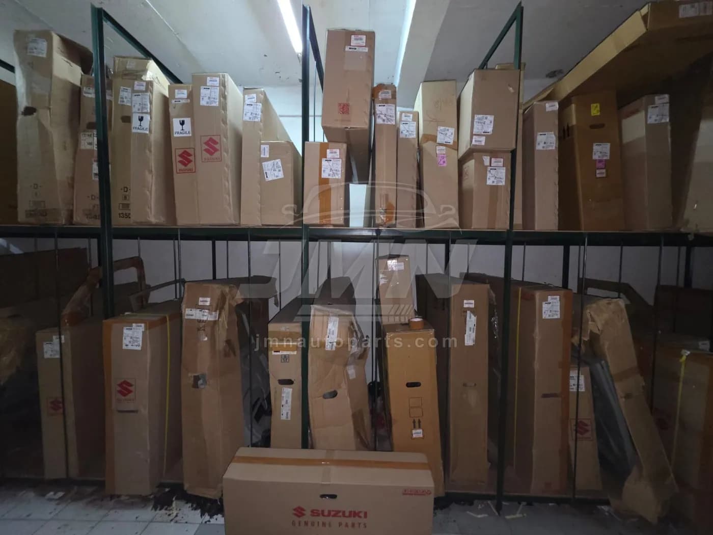 Two-tier racking filled with boxed Suzuki body panels and bumpers
